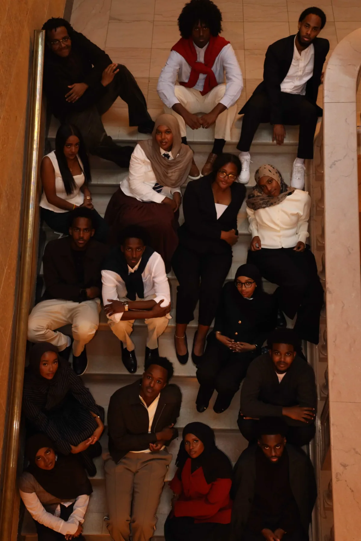 ColorStack UMN members seated together on a marble staircase